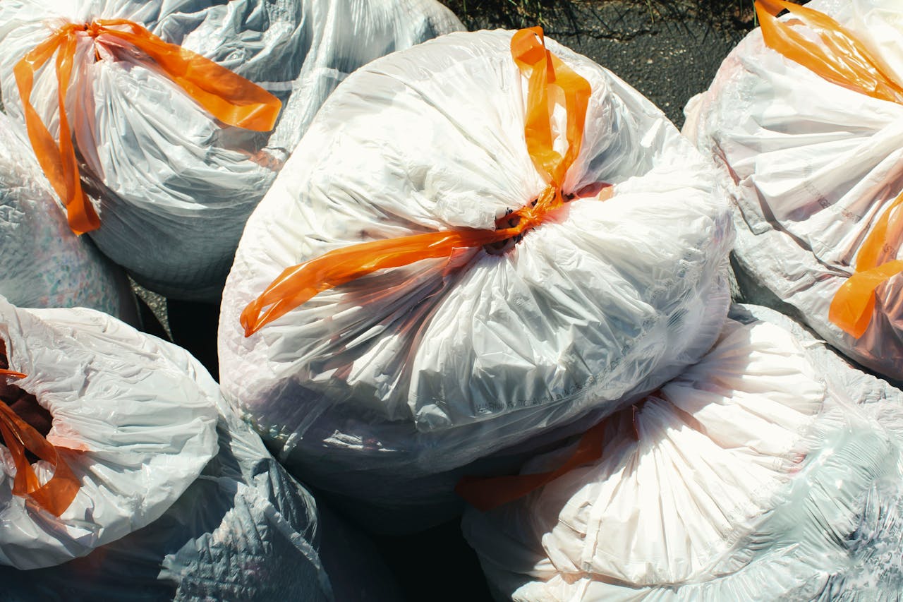 services-04 Bags of waste sealed with orange ties viewed from above.
